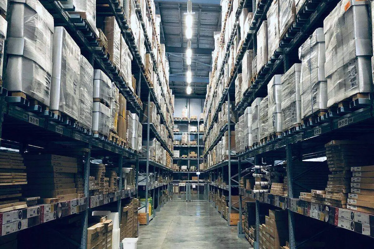 4K security cameras monitoring a warehouse interior with product aisles